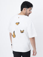 Model showcasing the back print of White orange butterflies oversized t-shirt on a white background.