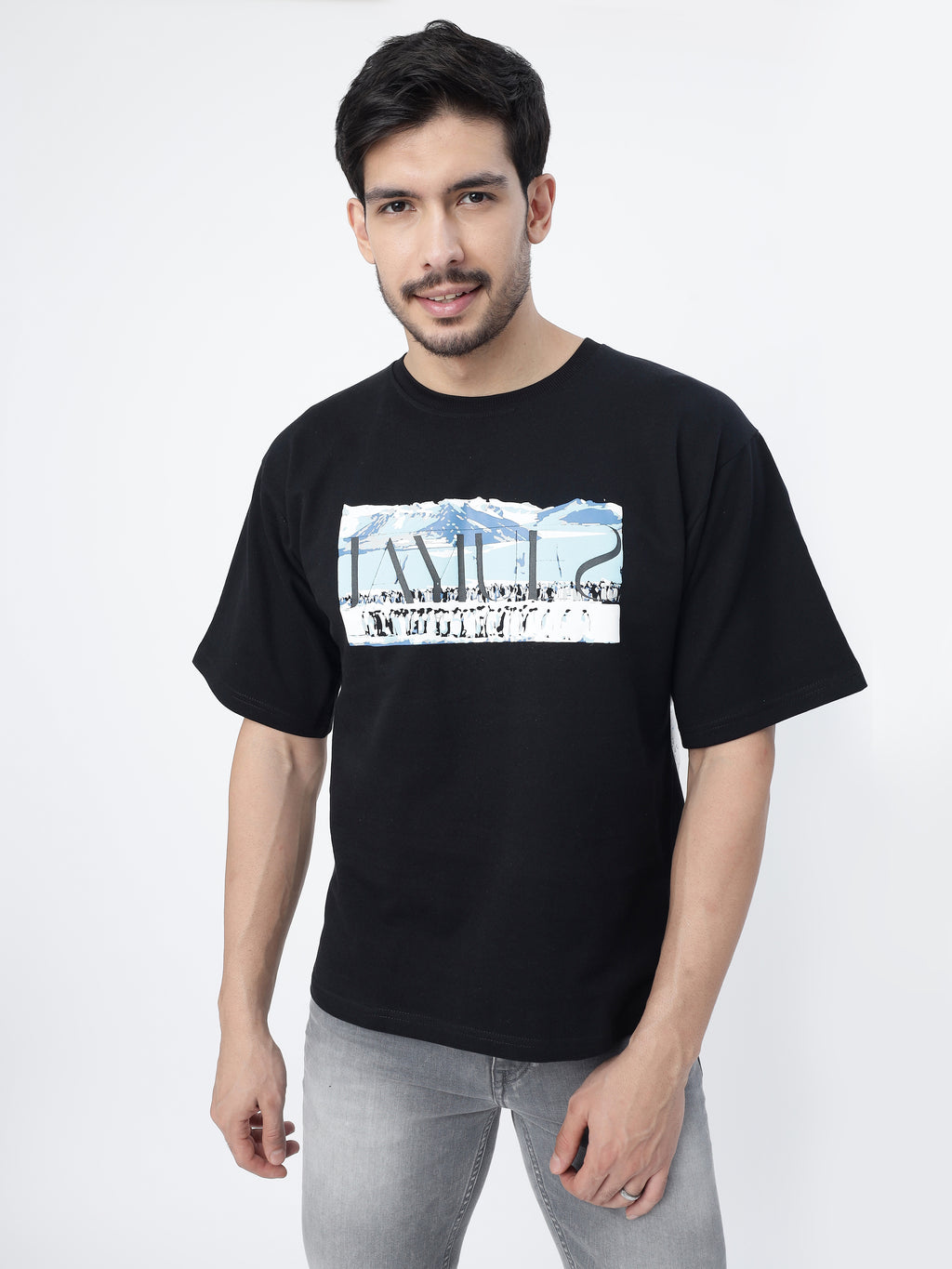 Model showcasing the front print of Black antarctic emperor oversized t-shirt, on a white background.