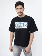 Model showcasing the front print of Black antarctic emperor oversized t-shirt, on a white background.