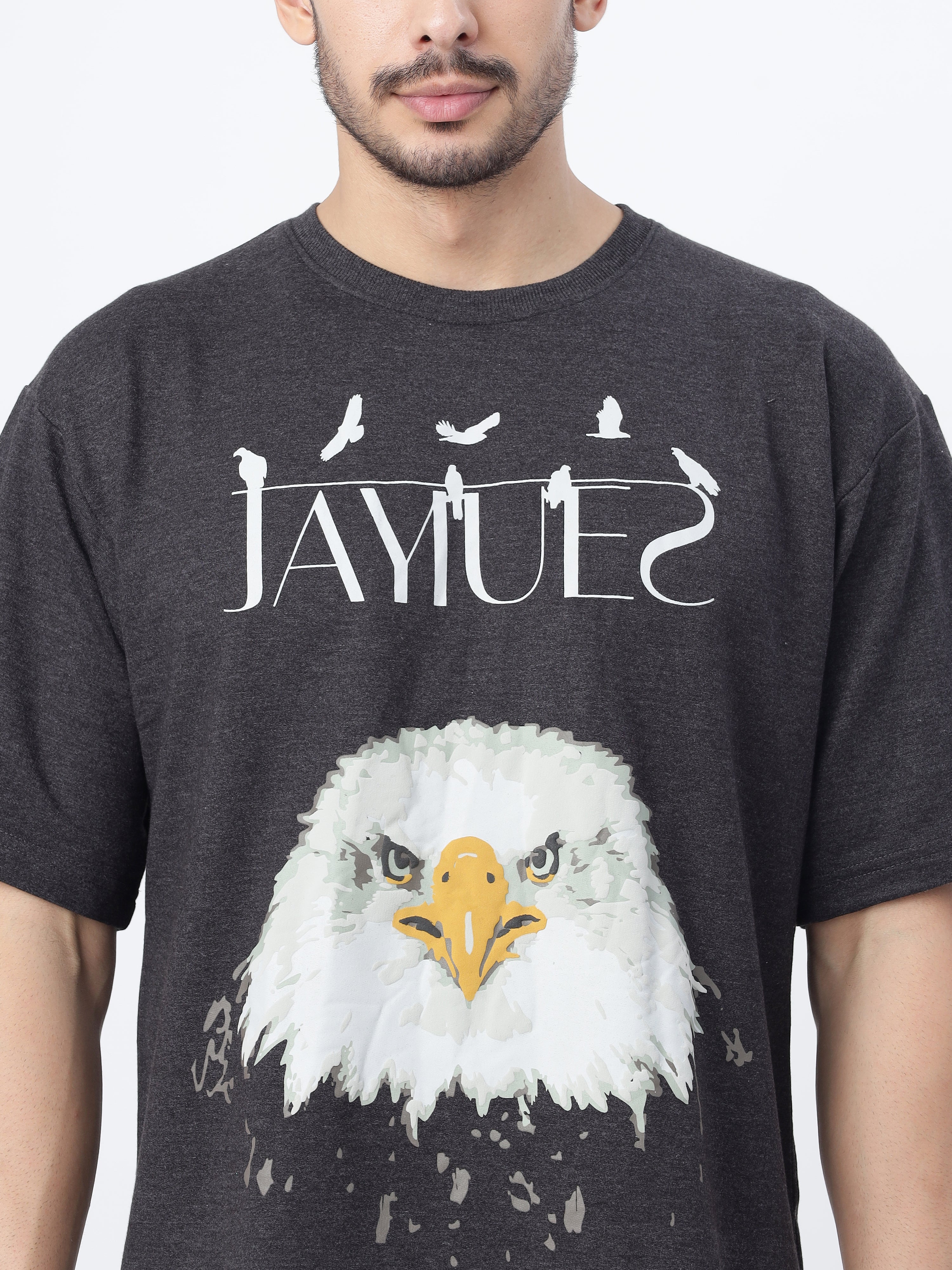 Closeup of a model showcasing the front print of Charcoal fat eagle oversized t-shirt on a white background.