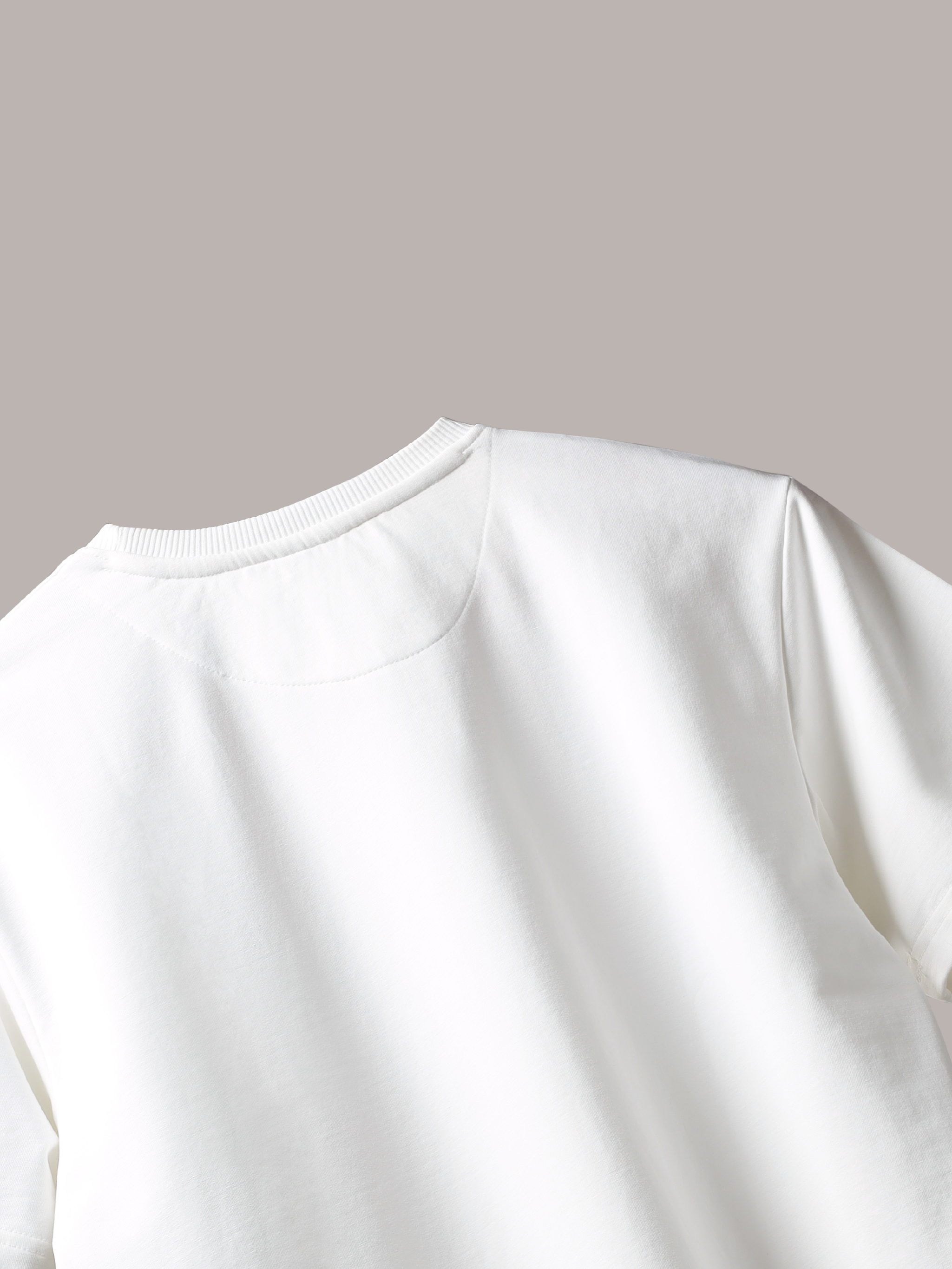 Close-up of a Jayhues White basic t-shirt on a light gray background