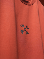 Close-up of the rust basic mark t-shirt featuring the HD printed black logo on the chest.