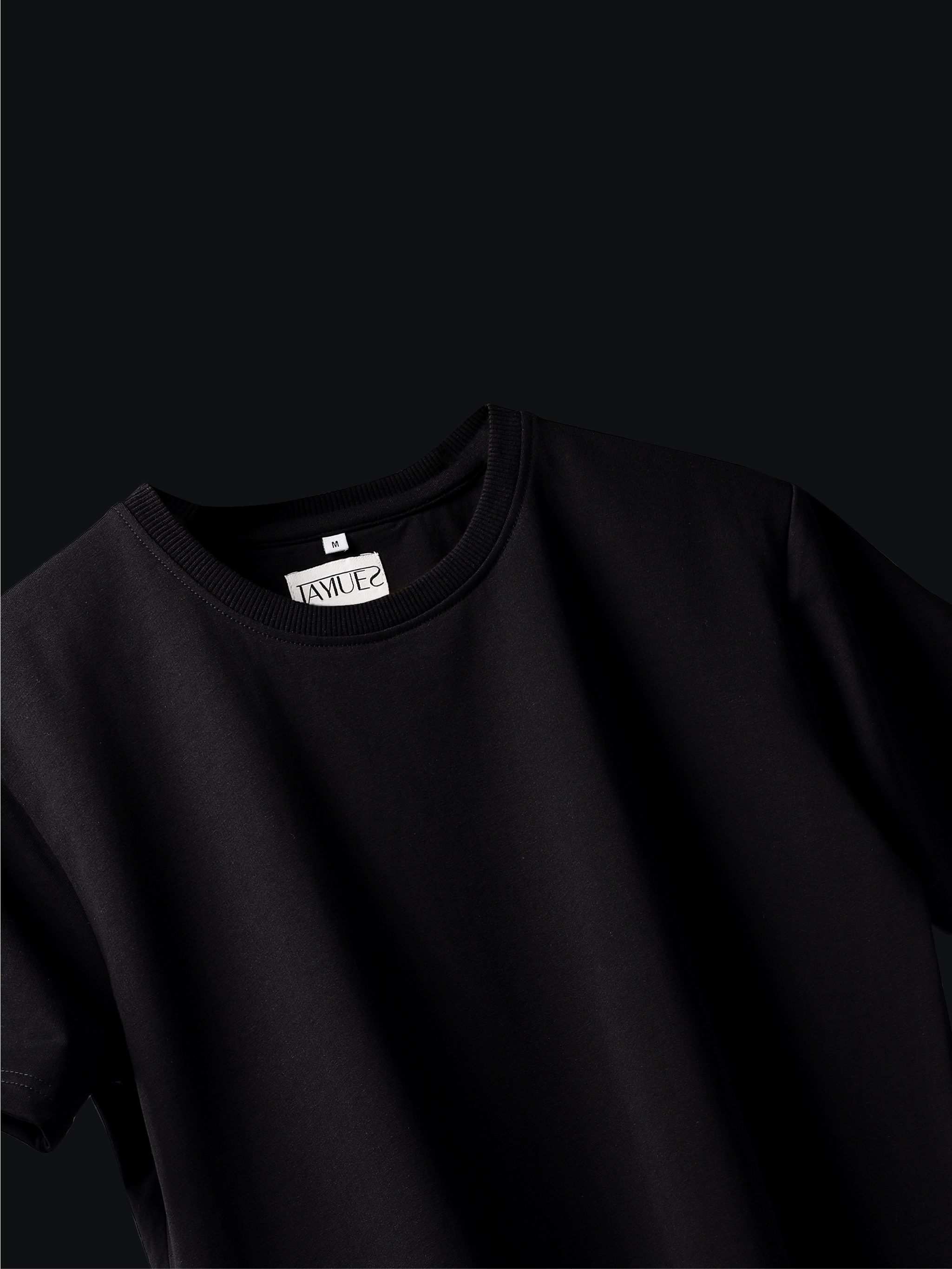 Jayhues black basic t-shirt with a brand label on a black background