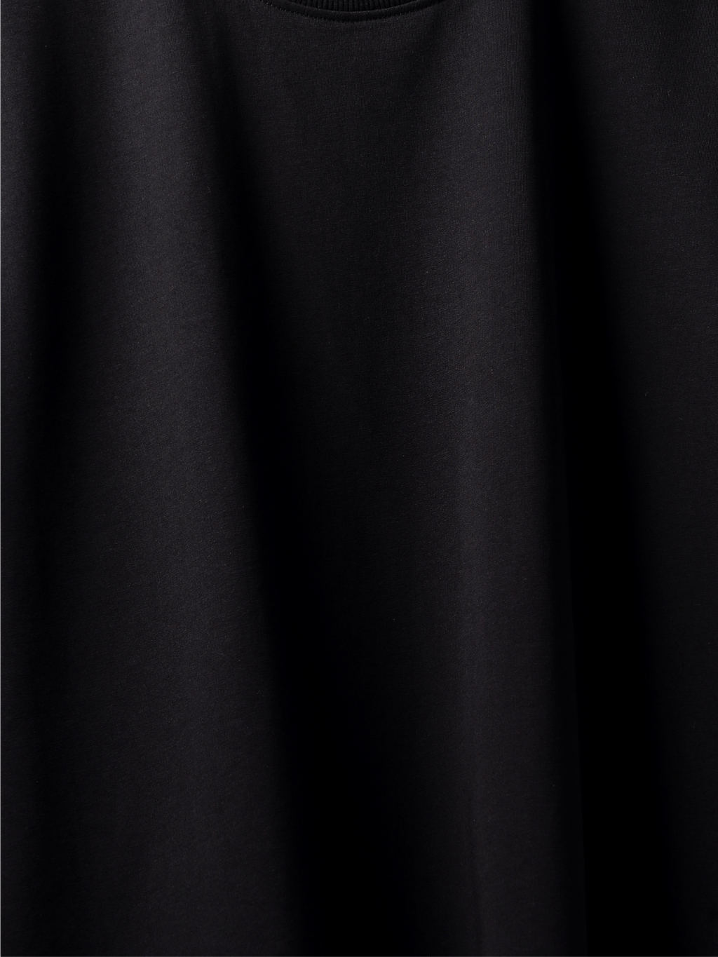Close-up of a plain black t-shirt with a soft texture.