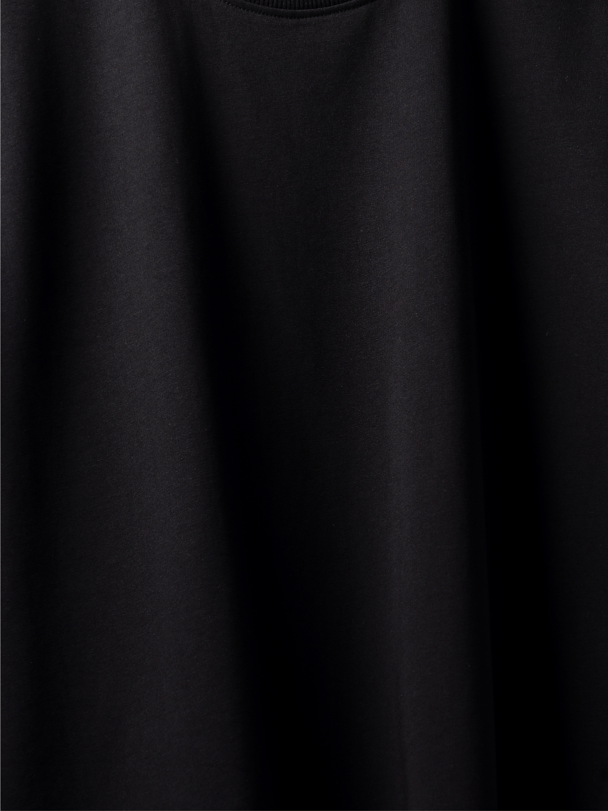 Close-up of a plain black t-shirt with a soft texture.