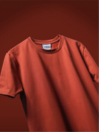 A rust basic t-shirt, shown against a matching dark rust-orange background.