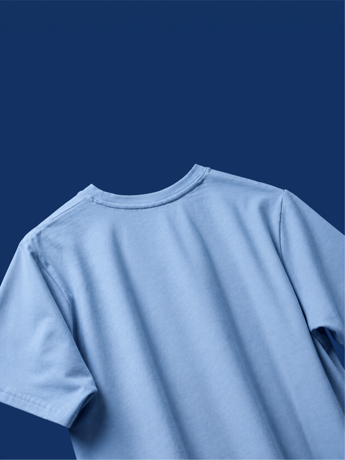 The light blue basic mark t-shirt shown from the back, photographed against a solid dark blue background.