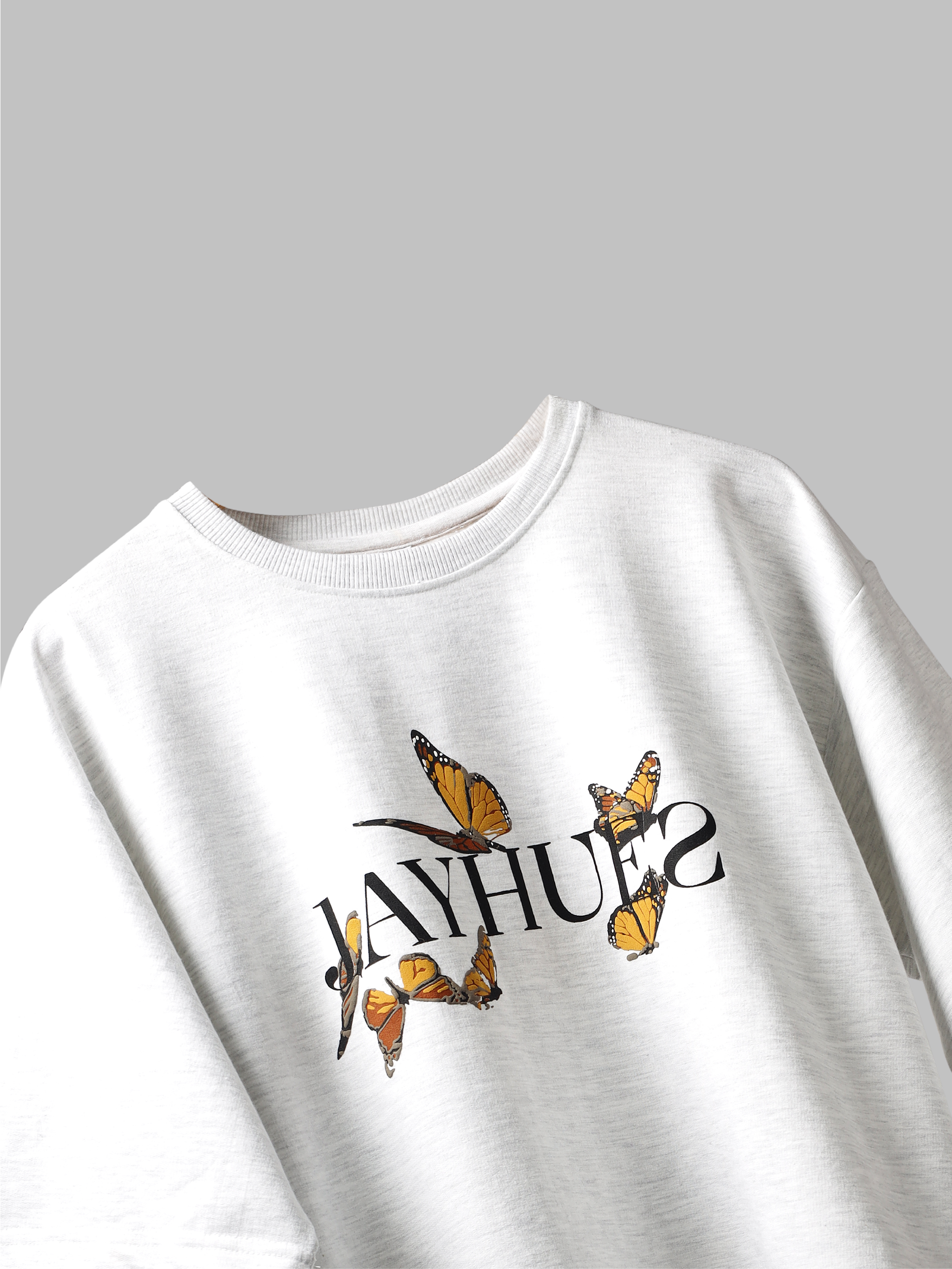 White yellow butterflies oversized t-shirt on a grey background.