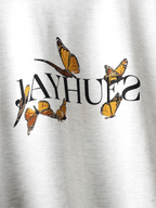 Closeup of front print on White yellow butterflies oversized t-shirt.
