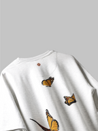 Back side of White yellow butterflies oversized t-shirt on grey background.