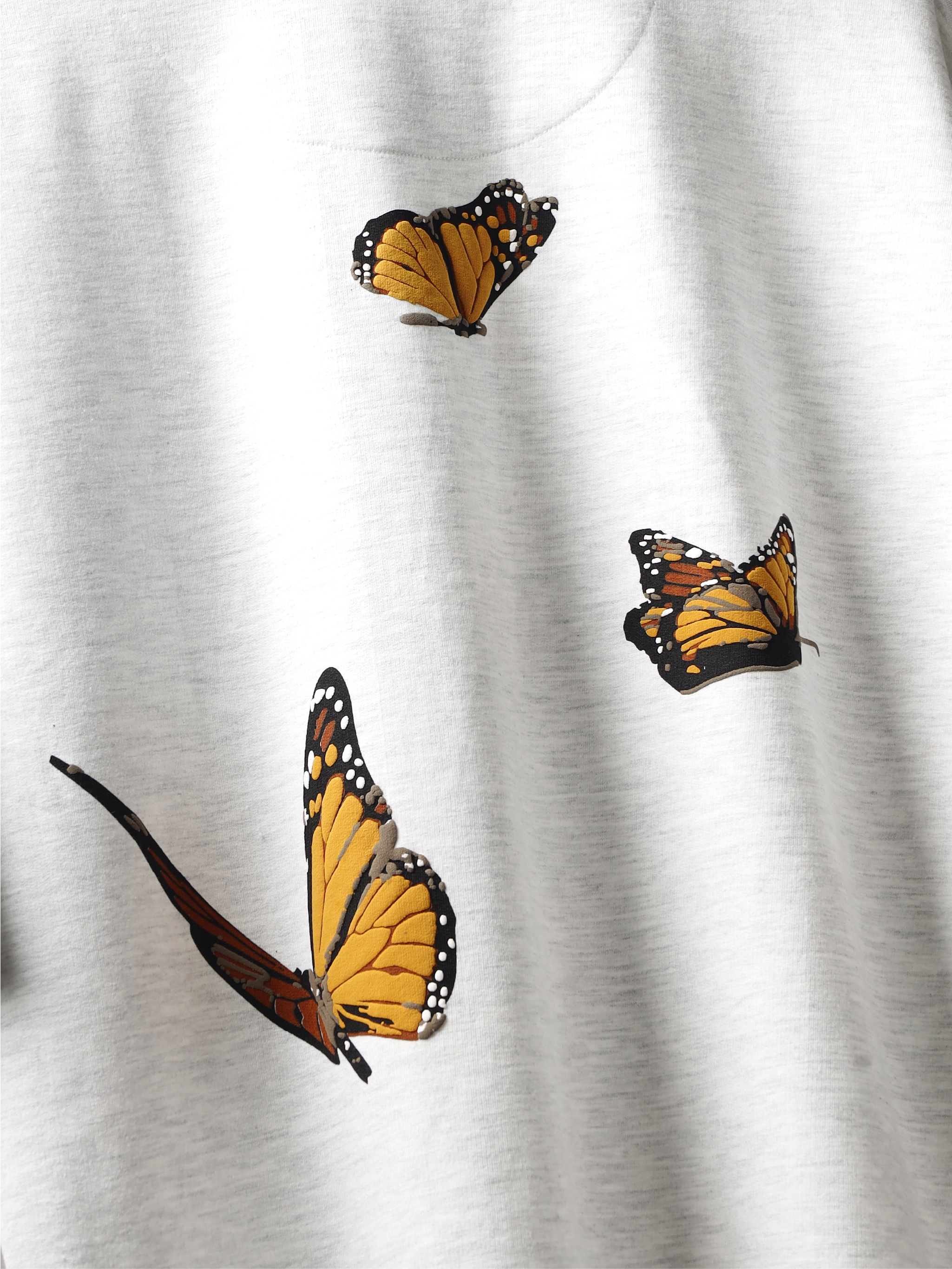 Closeup of back print on White yellow butterflies oversized t-shirt.