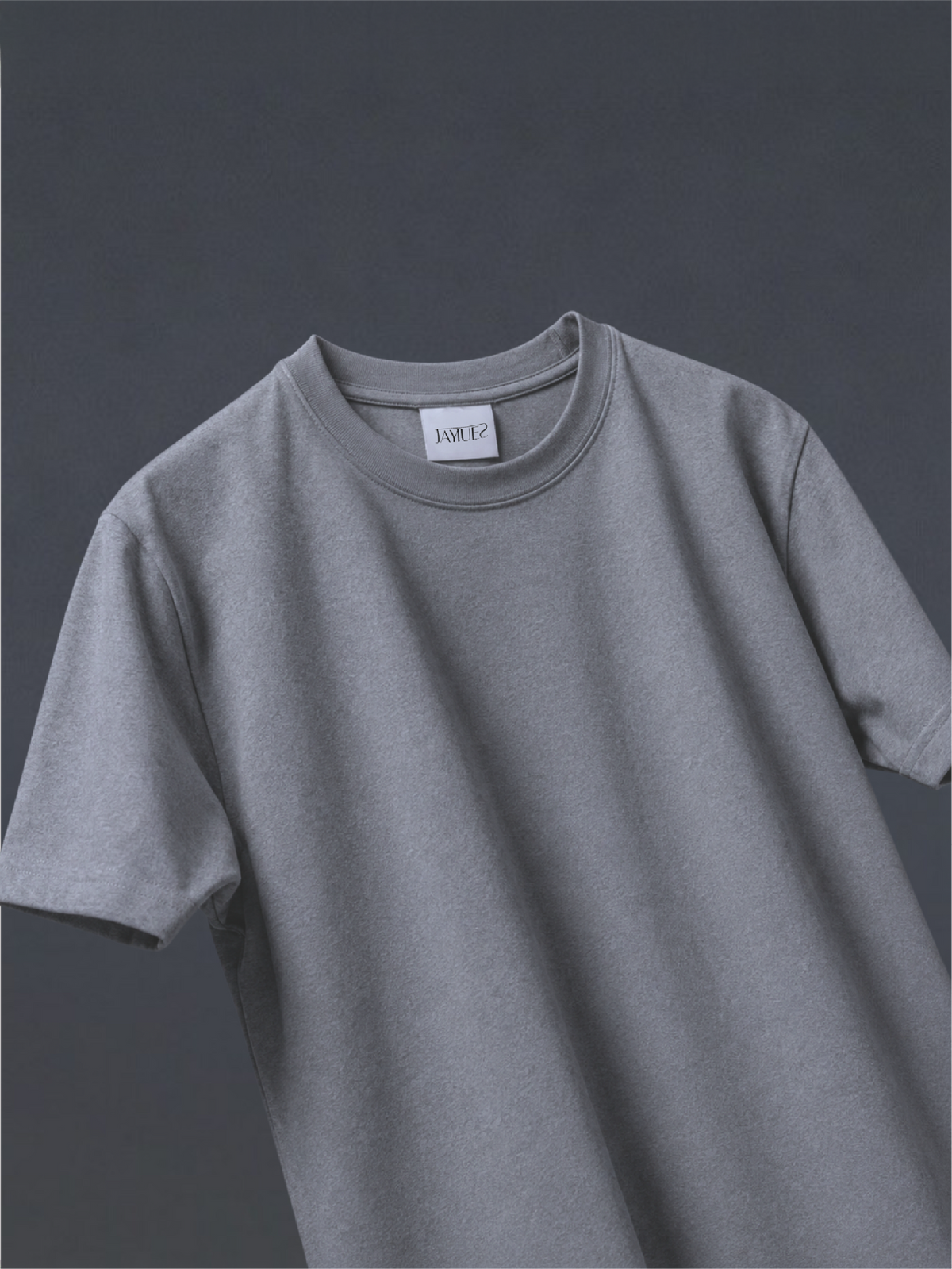 The grey basic t-shirt, shown against a dark grey background.