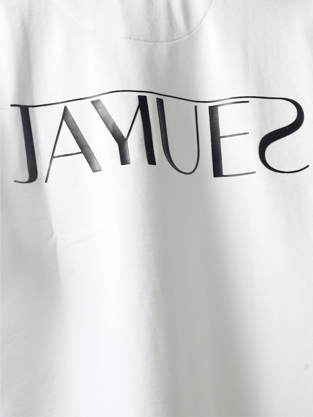 closeup of hd back logo on White jayhues marque t-shirt