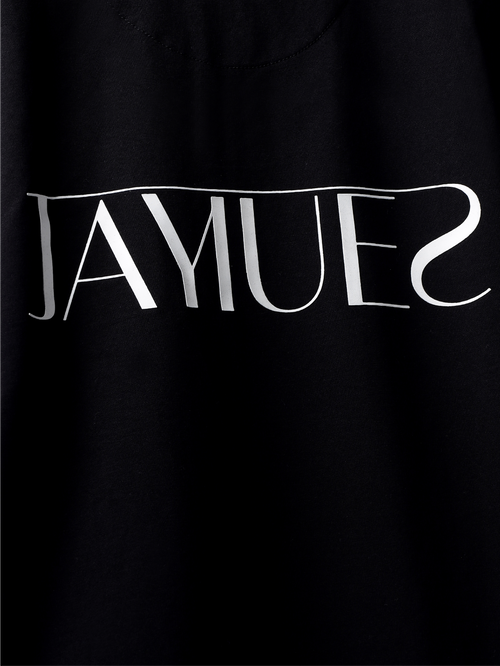 Closeup of white hd jayhues logo on the backside of Black jayhues marque t-shirt. 