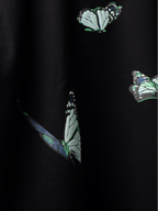 Close up of Butterfly pattern on a back of Black blue butterflies oversized t-shirt.
