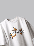 White orange butterflies oversized t-shirt on a grey background.