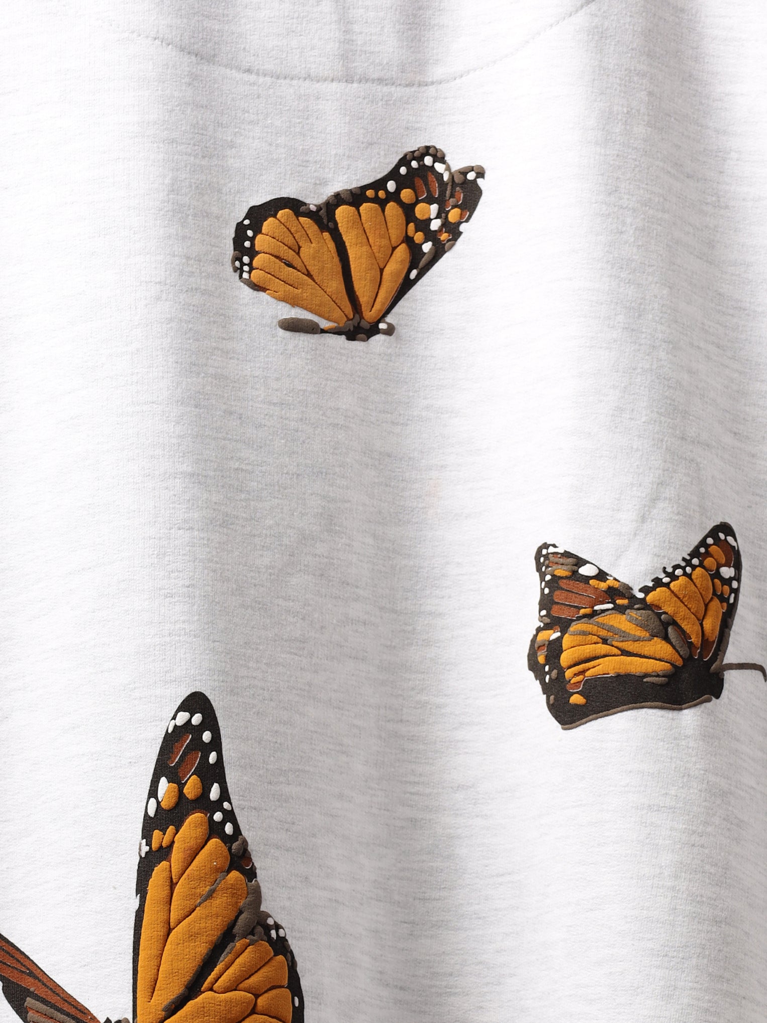Closeup of back print on White orange butterflies oversized t-shirt.