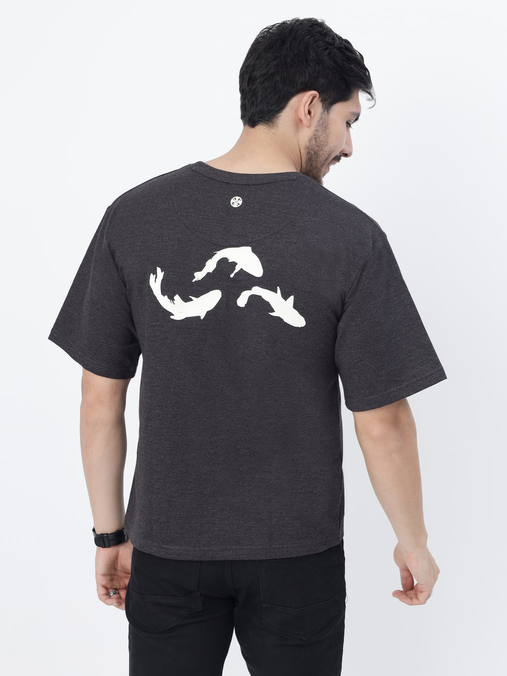 Model showcasing the back print of Charcoal Pisces Koi oversized t-shirt on a white background.