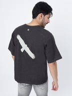 Model showcasing the back print of Charcoal fat eagle oversized t-shirt on a white background.